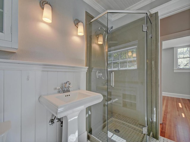 1203 W 22 1/2 St, Austin, TX 78705 - bathroom featuring a shower stall, ornamental molding, wood finished floors, wainscoting, and a decorative wall