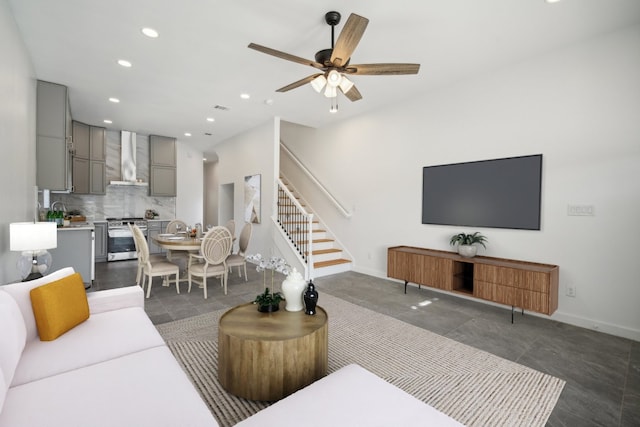 living room featuring recessed lighting, baseboards, stairs, and ceiling fan