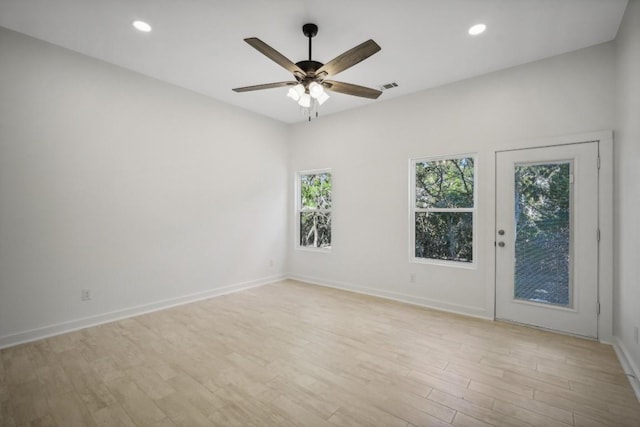 unfurnished room with visible vents, baseboards, recessed lighting, ceiling fan, and light wood-style floors