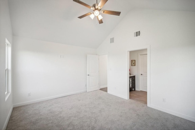 unfurnished bedroom featuring visible vents, baseboards, carpet, and high vaulted ceiling