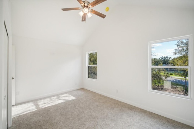 carpeted spare room featuring a ceiling fan, baseboards, and high vaulted ceiling