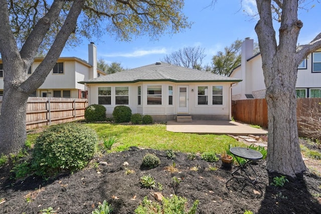 9408 Notches Dr, Austin, TX 78748 - rear view of house with a chimney, a fenced backyard, a yard, entry steps, and a patio area