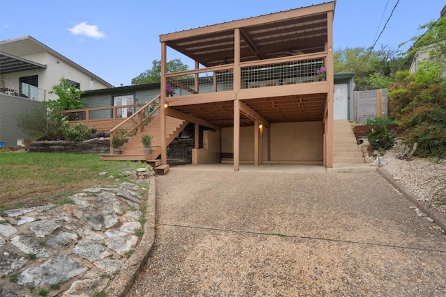 4004 Highland Dr, Austin, TX 78734 - back of property featuring stairway, a wooden deck, and driveway