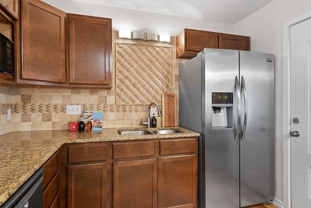 4004 Highland Dr, Austin, TX 78734 - kitchen with stainless steel fridge with ice dispenser, a sink, decorative backsplash, and light stone countertops