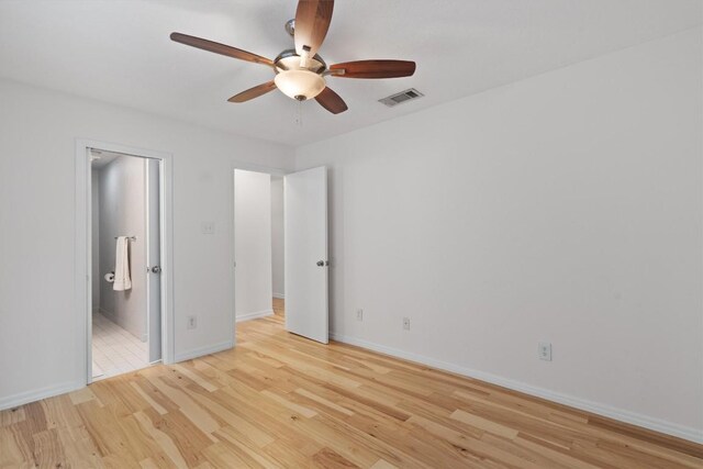 4004 Highland Dr, Austin, TX 78734 - unfurnished bedroom featuring light wood-style flooring, baseboards, ensuite bath, and a ceiling fan