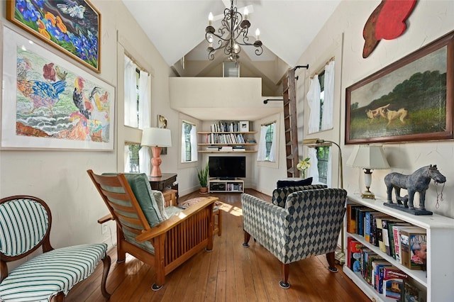 167 N Tumbleweed Trl, Austin, TX 78733 - living area featuring an inviting chandelier, hardwood / wood-style flooring, and high vaulted ceiling