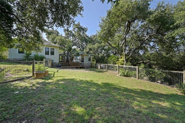 167 N Tumbleweed Trl, Austin, TX 78733 - view of yard featuring a wooden deck and a fenced backyard