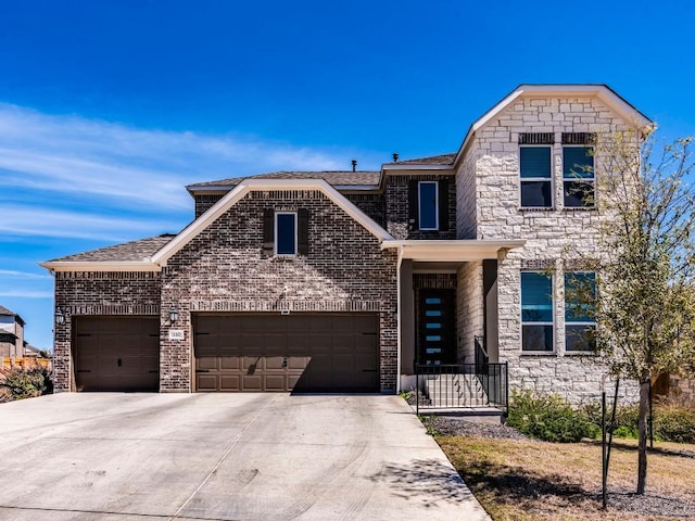 110 Pigeon River Rd, Kyle, TX 78640 - view of front of property featuring concrete driveway, a garage, a shingled roof, and brick siding