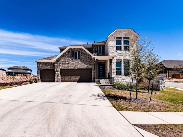 110 Pigeon River Rd, Kyle, TX 78640 - view of front facade with stone siding, a garage, and driveway