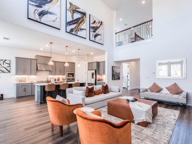 110 Pigeon River Rd, Kyle, TX 78640 - living room with light wood-style floors, a high ceiling, baseboards, and recessed lighting