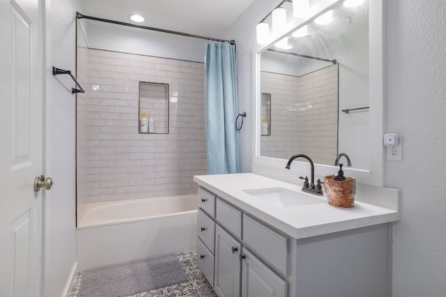 30228 Saint Andrews Dr, Georgetown, TX 78628 - full bath with vanity, shower / bath combination with curtain, a textured wall, and tile patterned flooring