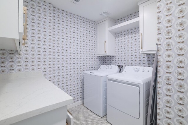 30228 Saint Andrews Dr, Georgetown, TX 78628 - laundry area featuring cabinet space, wallpapered walls, and separate washer and dryer