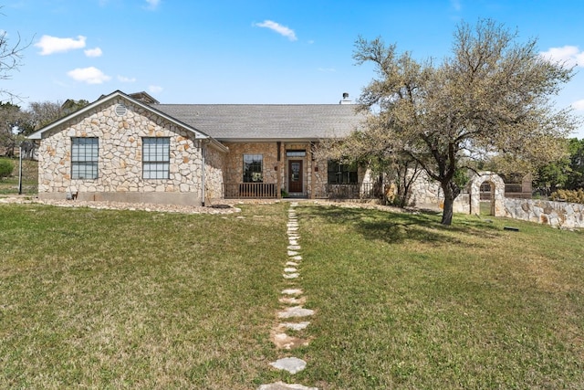 20106 Moon Dance Ln, Spicewood, TX 78669 - ranch-style home with a front yard, roof with shingles, and stone siding