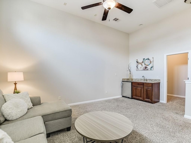 15218 Glen Heather Dr, Lakeway, TX 78734 - living room featuring bar with sink, ceiling fan, and light colored carpet