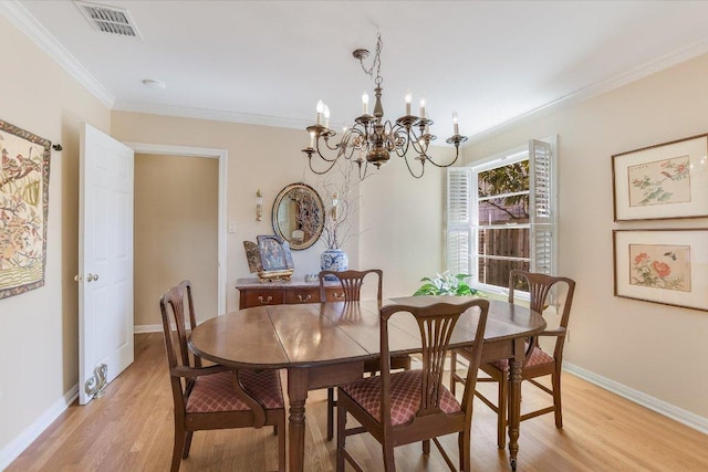 4010 Lewis Ln, Austin, TX 78756 - dining area with a chandelier, light wood-type flooring, ornamental molding, and baseboards
