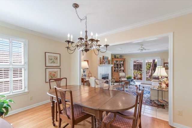 4010 Lewis Ln, Austin, TX 78756 - dining space featuring a fireplace, light wood-type flooring, ornamental molding, a chandelier, and baseboards