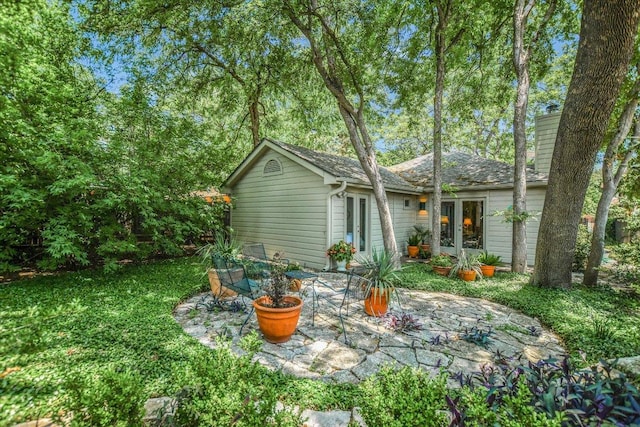 4010 Lewis Ln, Austin, TX 78756 - back of property with french doors, a patio, and a chimney