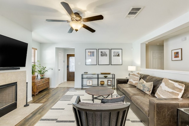 837 Watson Way, Pflugerville, TX 78660 - living room with ceiling fan, a fireplace, and wood finished floors
