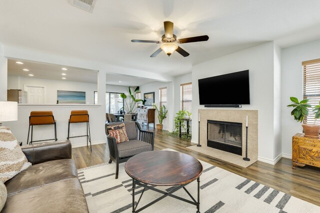 837 Watson Way, Pflugerville, TX 78660 - living area with plenty of natural light, wood finished floors, ceiling fan, a fireplace, and recessed lighting