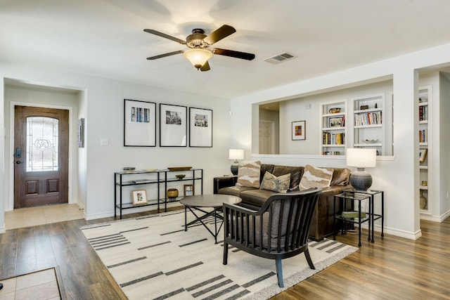 837 Watson Way, Pflugerville, TX 78660 - living area with a ceiling fan, wood finished floors, and built in shelves