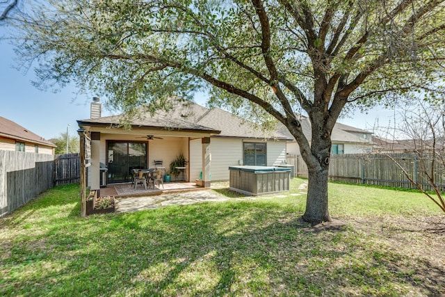 837 Watson Way, Pflugerville, TX 78660 - back of property featuring ceiling fan, a chimney, a fenced backyard, a hot tub, and a patio area