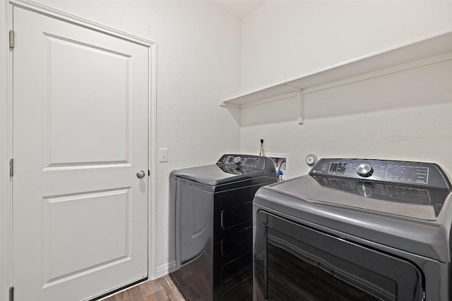 410 Seneca Loop, Kyle, TX 78640 - laundry room featuring washer and clothes dryer, wood finished floors, laundry area, and baseboards