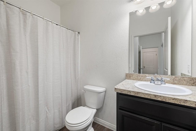 410 Seneca Loop, Kyle, TX 78640 - full bathroom featuring vanity, baseboards, toilet, and wood finished floors
