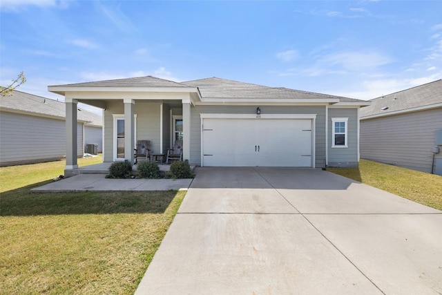 410 Seneca Loop, Kyle, TX 78640 - single story home with concrete driveway, a front yard, an attached garage, and covered porch