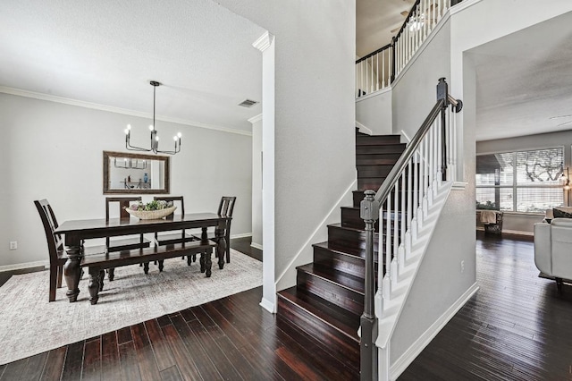 stairway featuring baseboards, visible vents, a notable chandelier, ornamental molding, and wood-type flooring