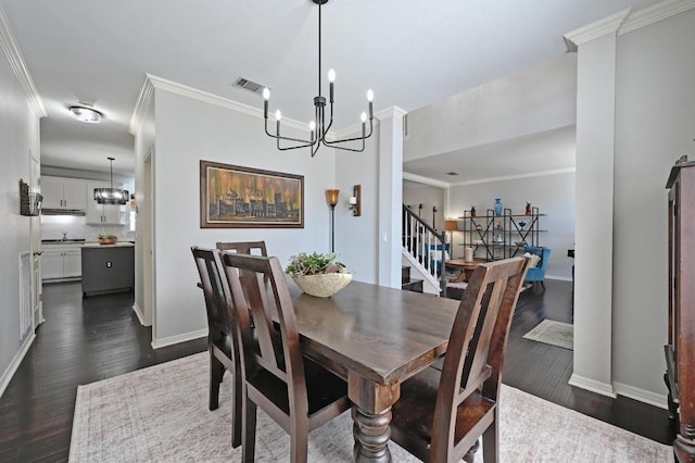 dining room with an inviting chandelier, ornamental molding, and baseboards