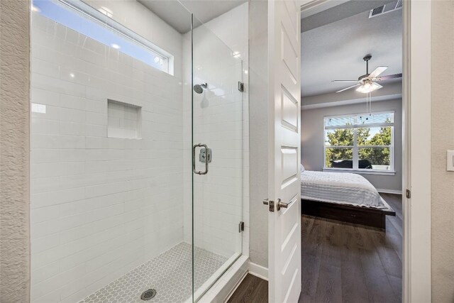 329 Peace Pipe Way, Georgetown, TX 78628 - full bath with wood finished floors, ensuite bathroom, a shower stall, and healthy amount of natural light