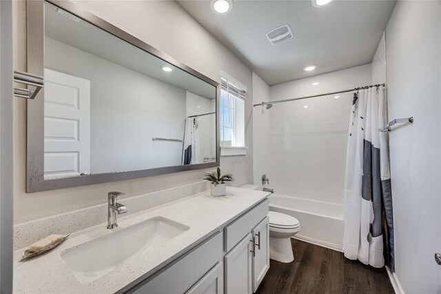 329 Peace Pipe Way, Georgetown, TX 78628 - full bath featuring vanity, toilet, shower / bath combination with curtain, wood finished floors, and recessed lighting