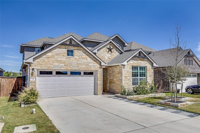 329 Peace Pipe Way, Georgetown, TX 78628 - craftsman-style home with stone siding, driveway, a garage, and a shingled roof