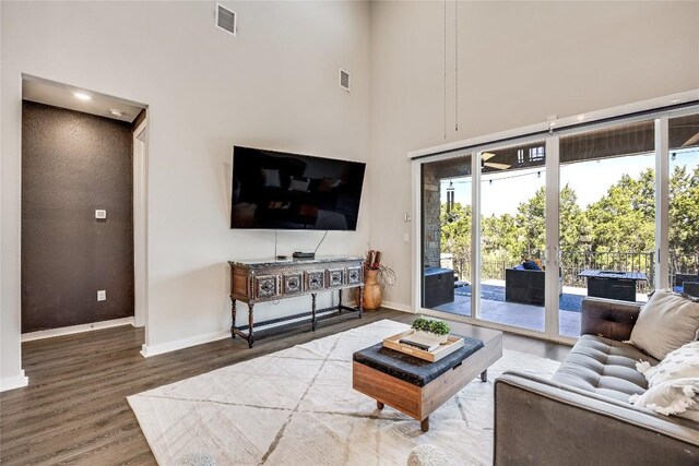 329 Peace Pipe Way, Georgetown, TX 78628 - living room with a high ceiling, wood finished floors, and baseboards