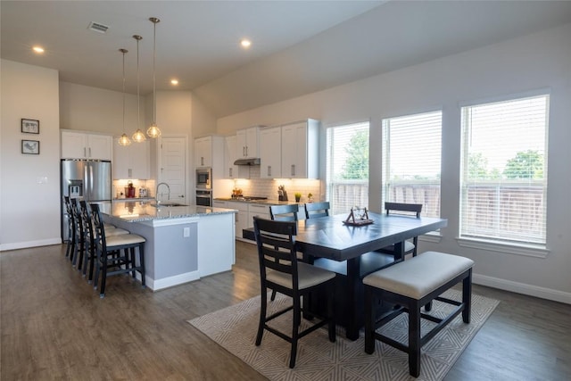 896 Spinnaker Loop, Kyle, TX 78640 - dining room featuring dark wood finished floors, vaulted ceiling, and recessed lighting
