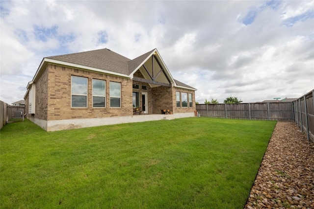 896 Spinnaker Loop, Kyle, TX 78640 - rear view of property featuring brick siding, a fenced backyard, roof with shingles, and a patio