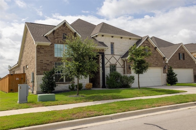 896 Spinnaker Loop, Kyle, TX 78640 - view of front of home with stone siding, brick siding, driveway, and a front yard