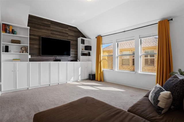 carpeted living area with vaulted ceiling
