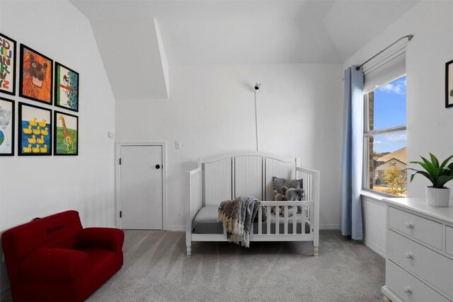 carpeted bedroom featuring baseboards and vaulted ceiling