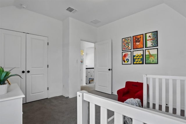 bedroom with baseboards, visible vents, dark carpet, and a closet