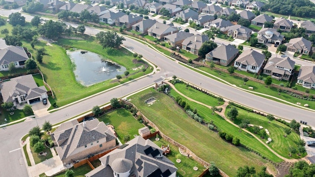 birds eye view of property with a water view and a residential view