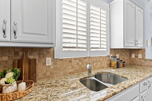 100 Blacksmiths Cir, Georgetown, TX 78633 - kitchen featuring white cabinetry, decorative backsplash, and light stone counters