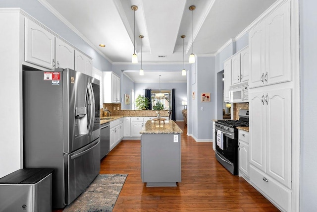 100 Blacksmiths Cir, Georgetown, TX 78633 - kitchen with appliances with stainless steel finishes, a peninsula, white cabinets, tasteful backsplash, and light stone counters
