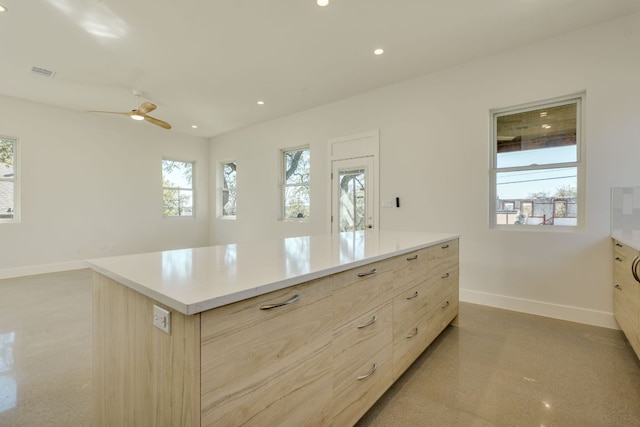 3014 Brass Buttons Trl, Austin, TX 78734 - kitchen with light brown cabinets, ceiling fan, light countertops, a center island, and modern cabinets