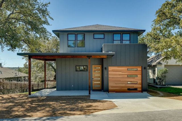 3014 Brass Buttons Trl, Austin, TX 78734 - view of front of home with board and batten siding, concrete driveway, a garage, and roof with shingles