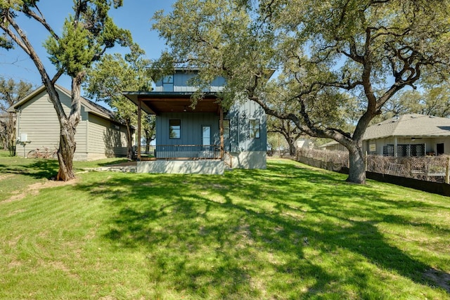 3014 Brass Buttons Trl, Austin, TX 78734 - rear view of house featuring board and batten siding, covered porch, and a lawn