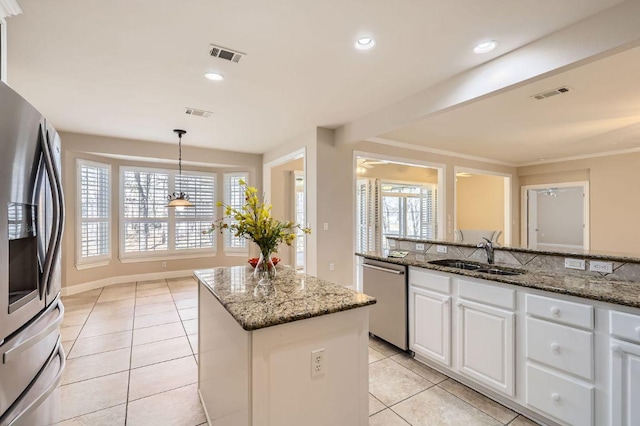 407 Breezeway Ln, Georgetown, TX 78633 - kitchen with light tile patterned floors, visible vents, stainless steel appliances, and a sink