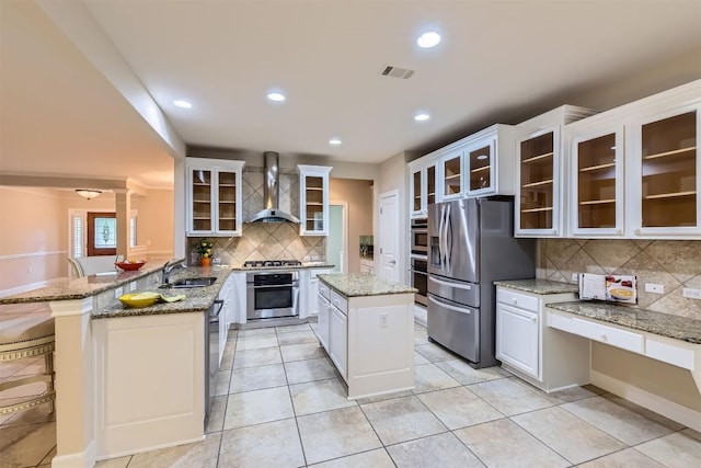 407 Breezeway Ln, Georgetown, TX 78633 - kitchen with decorative backsplash, stainless steel appliances, wall chimney range hood, a sink, and visible vents