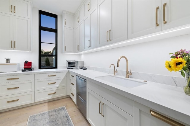 5805 Twin Peaks Trce, Austin, TX 78738 - kitchen with stainless steel dishwasher, light countertops, and white cabinets