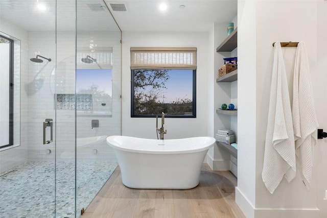 5805 Twin Peaks Trce, Austin, TX 78738 - full bathroom featuring a shower stall, wood finished floors, and plenty of natural light